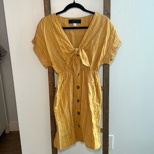 Summer mini dress with peek a boo and tie. Mustard yellow and short sleeves.